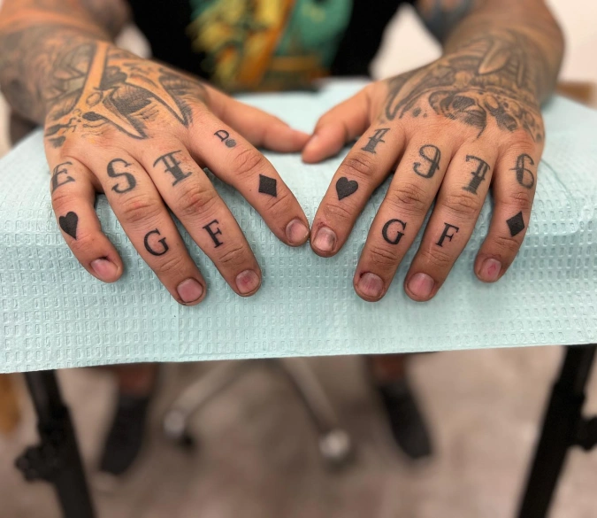 Layered Knuckle Script And Geometric Card Suits