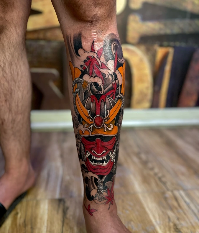 Red Samurai Mask And Golden Helmet Calf Tattoo